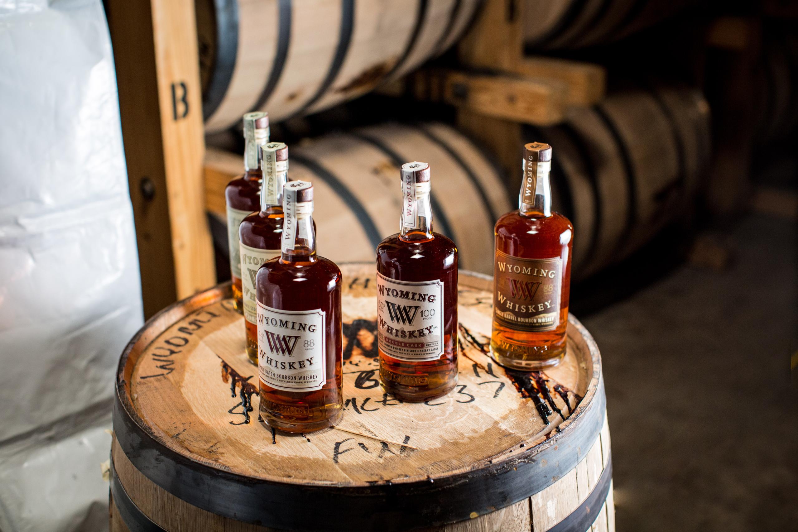 five bottles on top of a cask