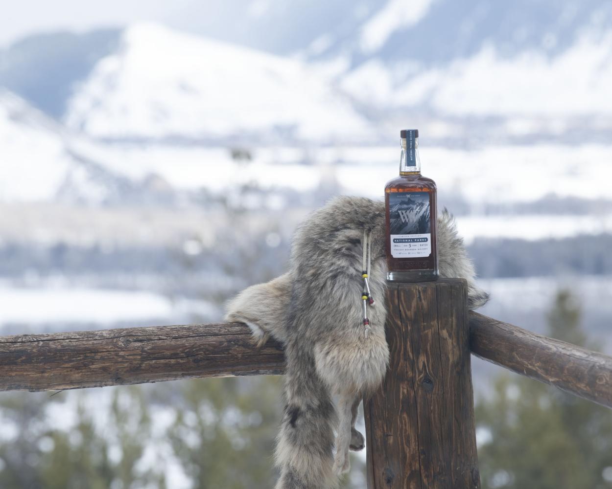 Whiskey bottle on a wooden railing