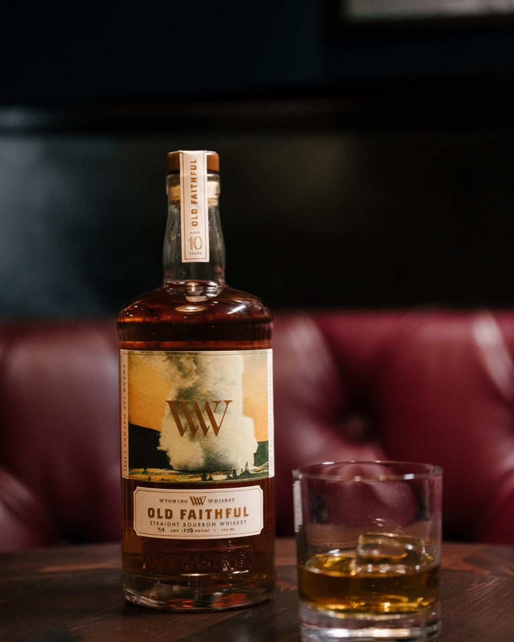 bottle of whiskey with glass of whiskey