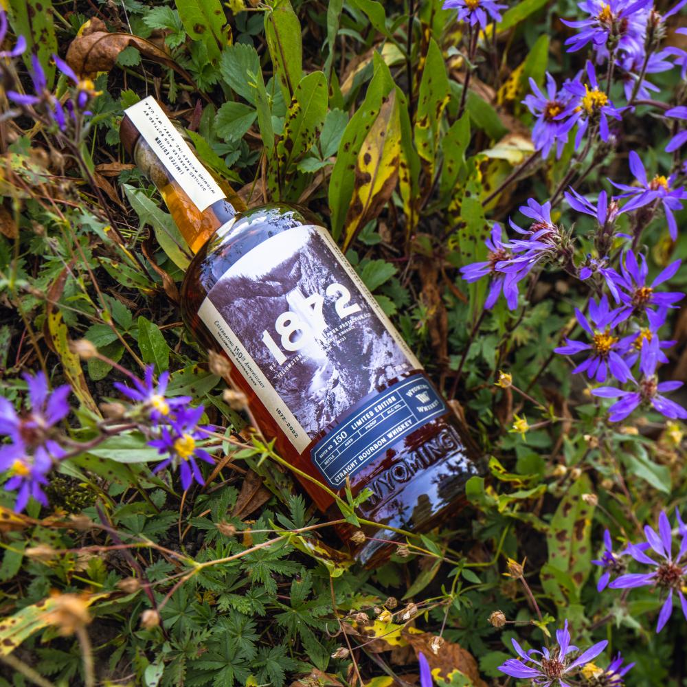 Bottle of whiskey in a bundle of lavender 