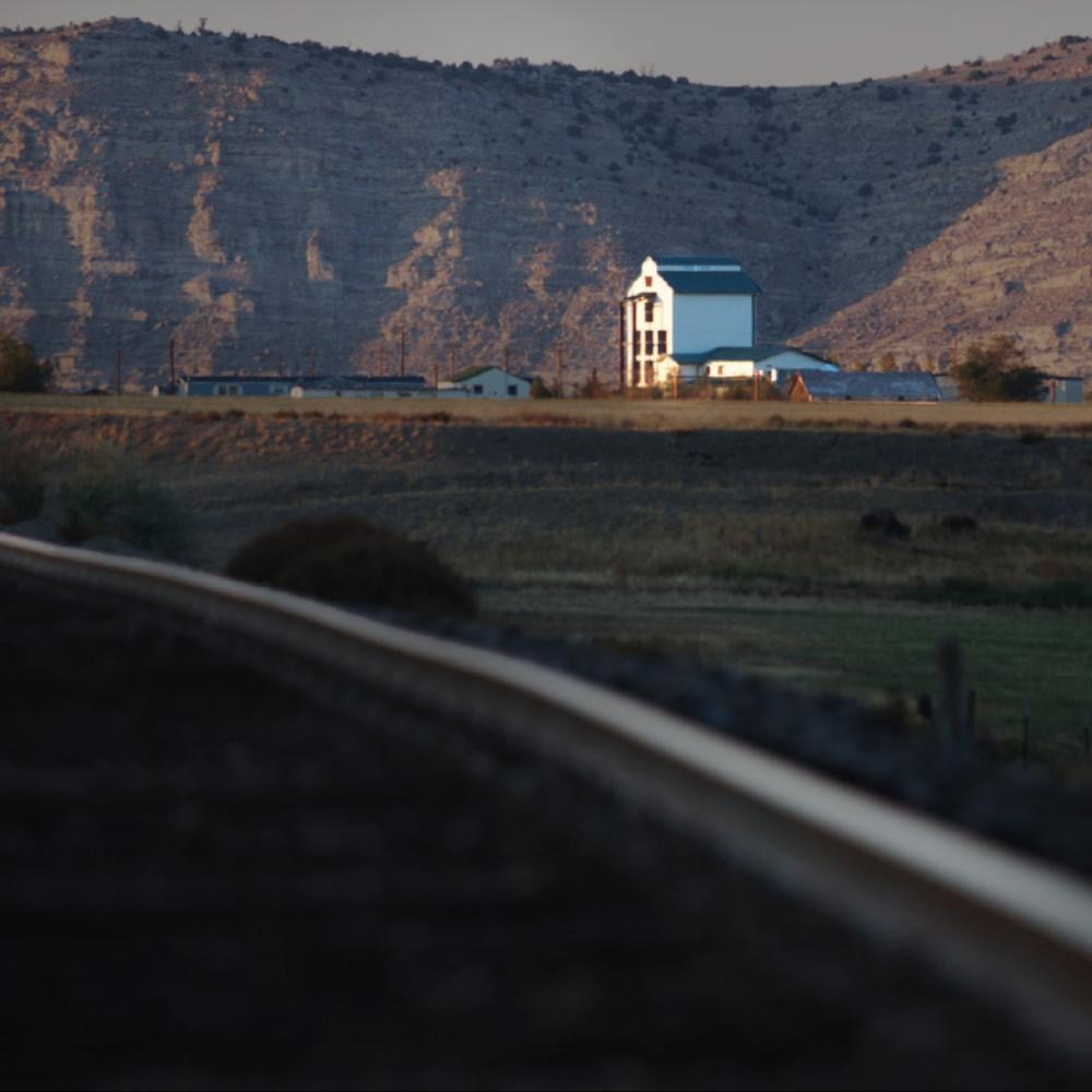 Railroad with a distillery in the distance