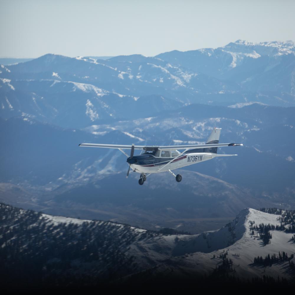 Airplane flying above mountains