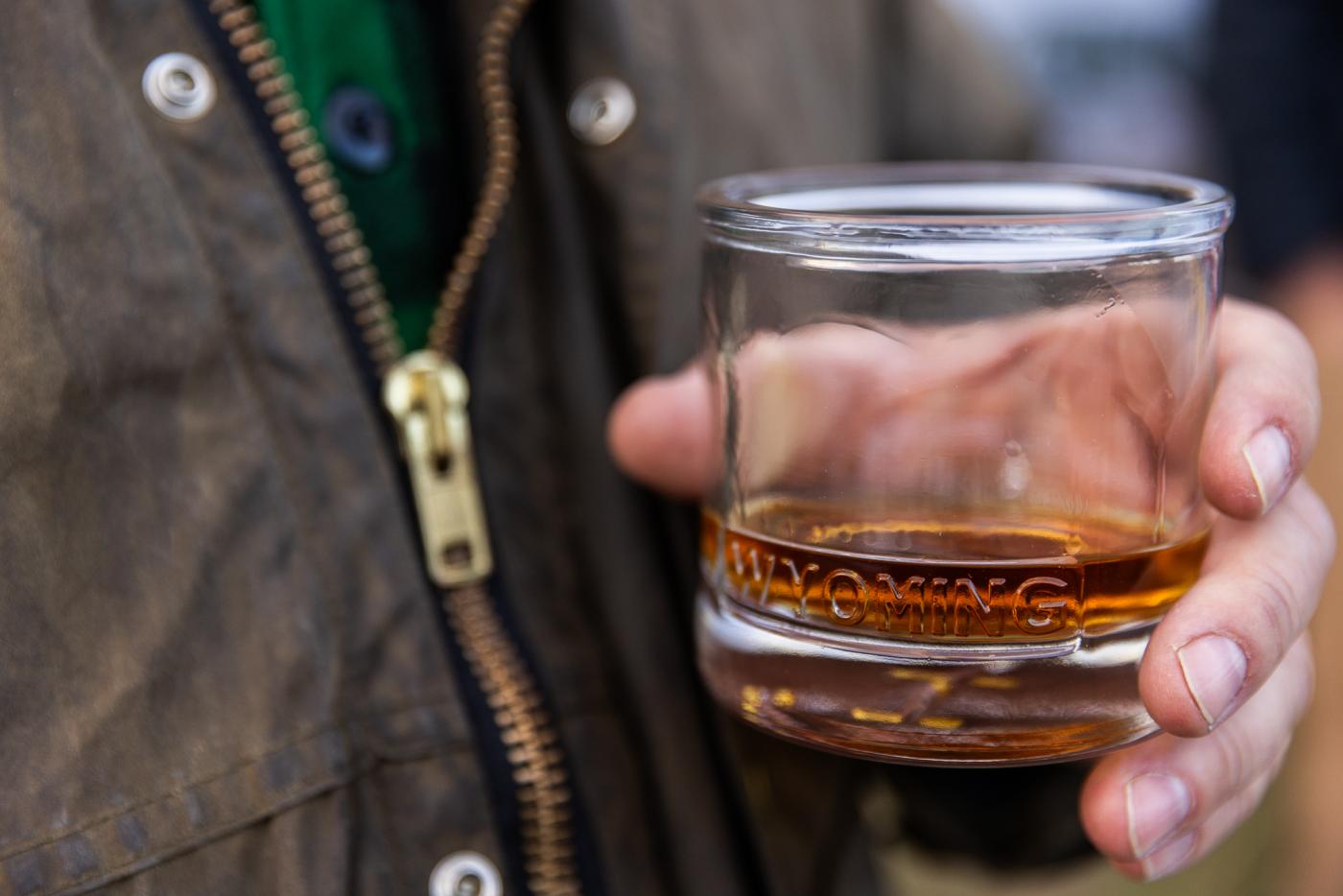 Man holding a glass of whiskey